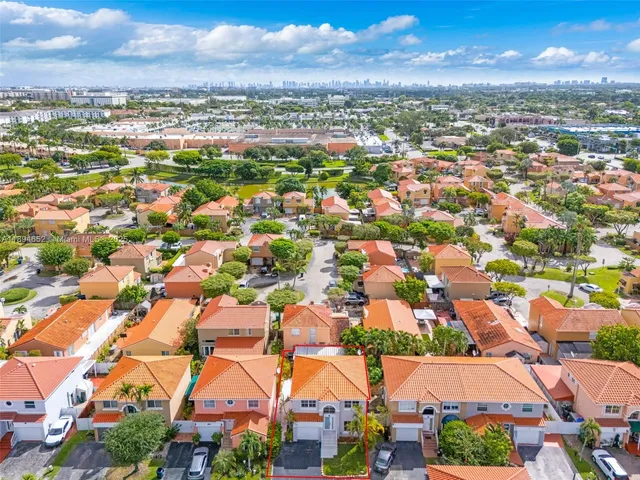 an aerial view of residential houses with outdoor space and street view