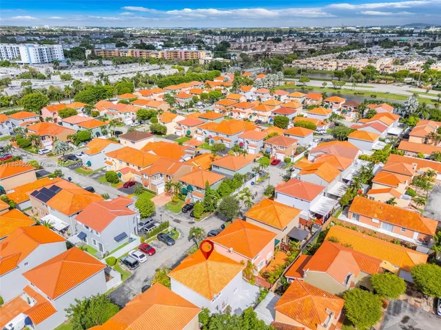 an aerial view of residential houses with outdoor space and river
