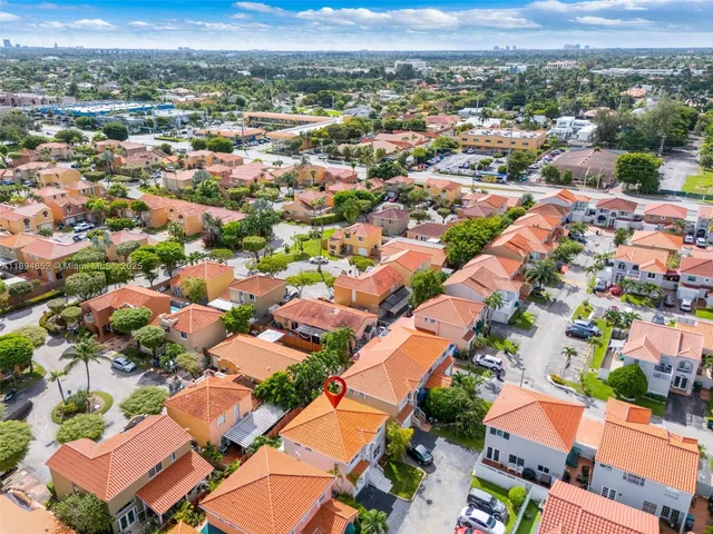an aerial view of residential houses with outdoor space
