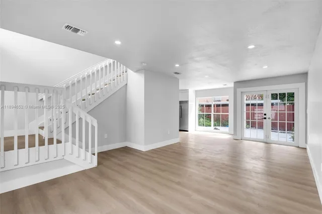a view of an entryway with wooden floor