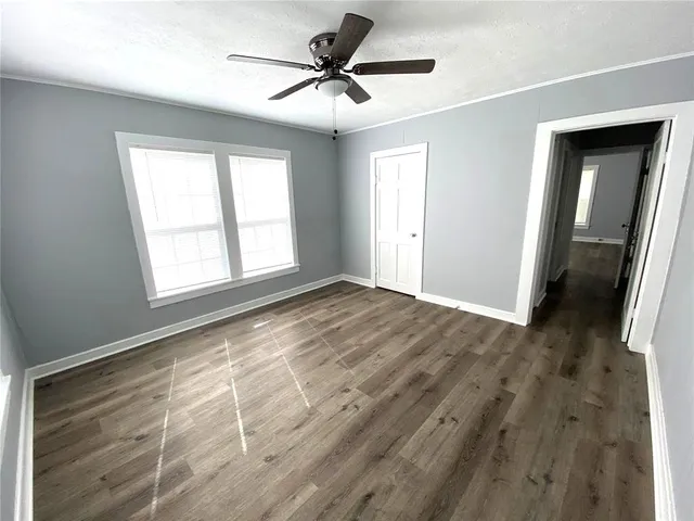 a view of a livingroom with a window and a ceiling fan