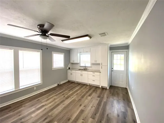 a view of a kitchen with a sink and cabinet area