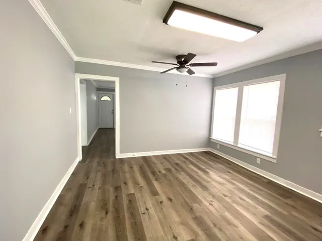 wooden floor in an empty room with a window