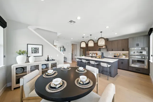 a large kitchen with a table and chairs