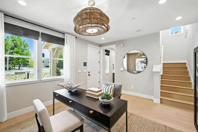 a view of a dining room with a table and chairs