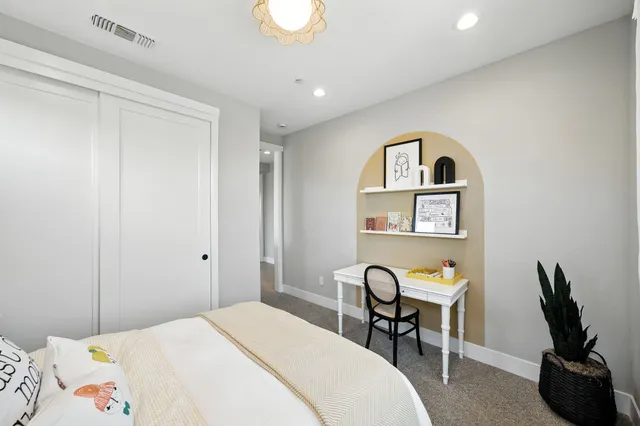 a bedroom with a bed and a couch