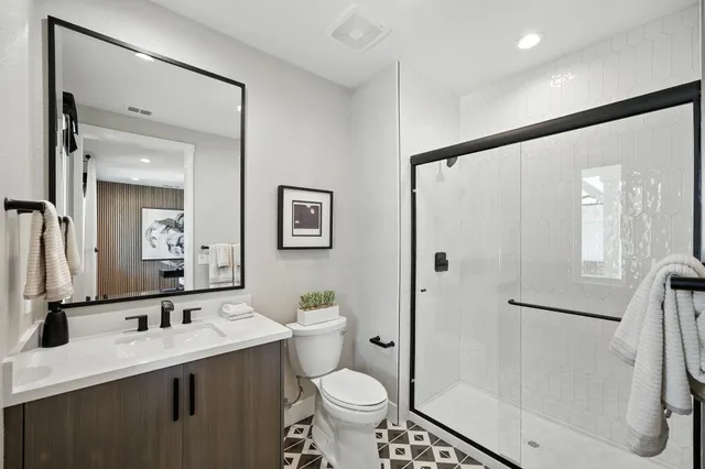 a bathroom with a sink toilet and shower