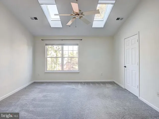 a view of room with a ceiling fan