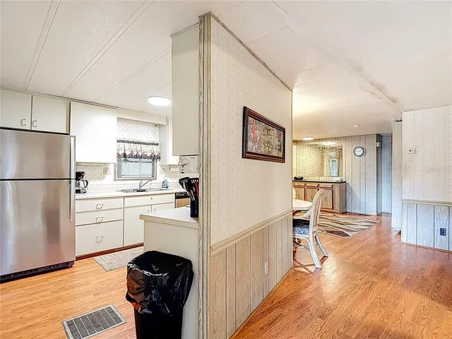 a kitchen with stainless steel appliances granite countertop a stove and white cabinets