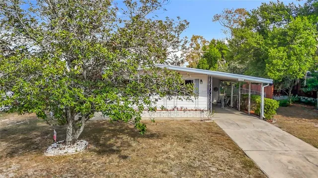 a view of house with backyard space and sitting area