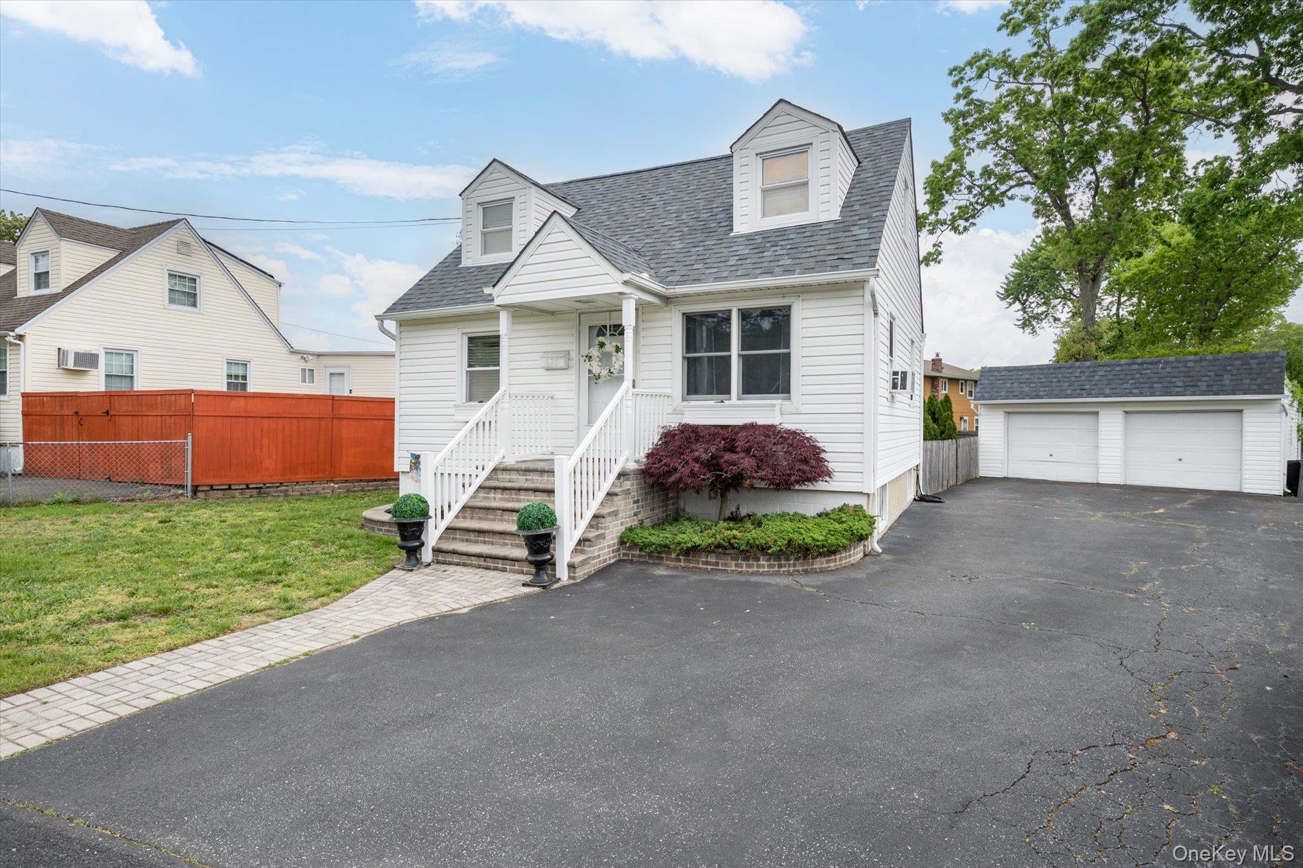 675 Little E Neck Road West Babylon, NY 11704 - Photo 2 of 20 a front view of a house with a garden and parking