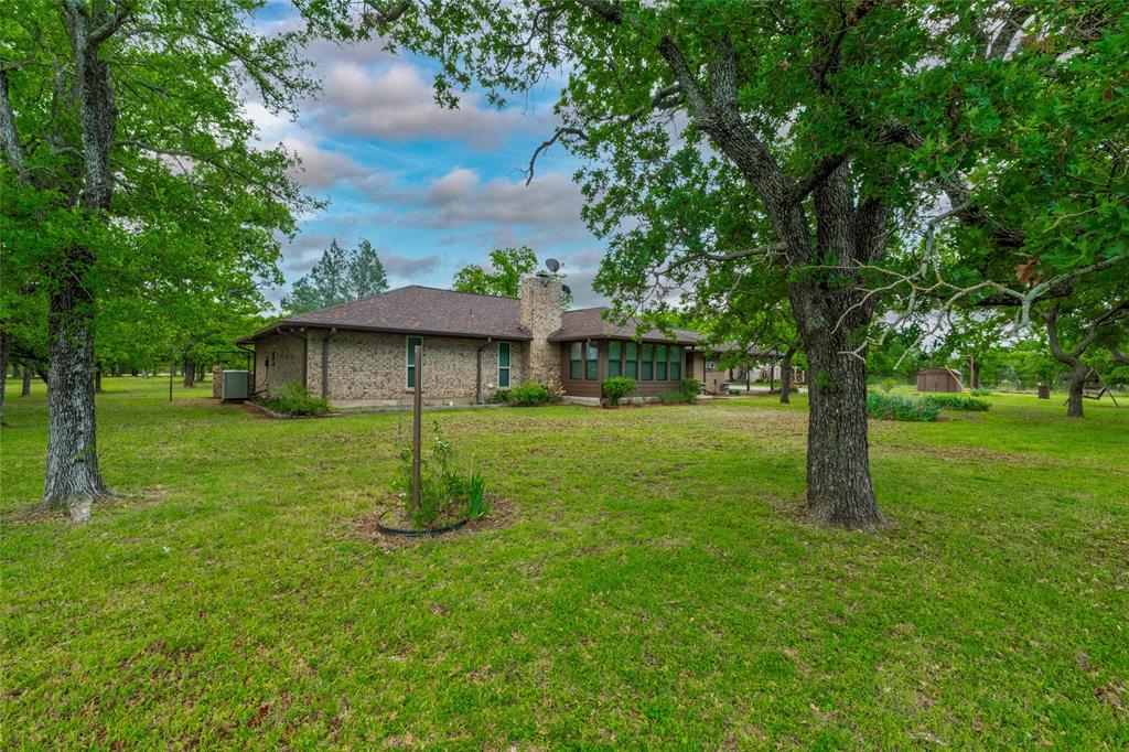 970 Live Oak Road Santo, TX 76472 - Photo 6 of 40 a front view of a house with a yard