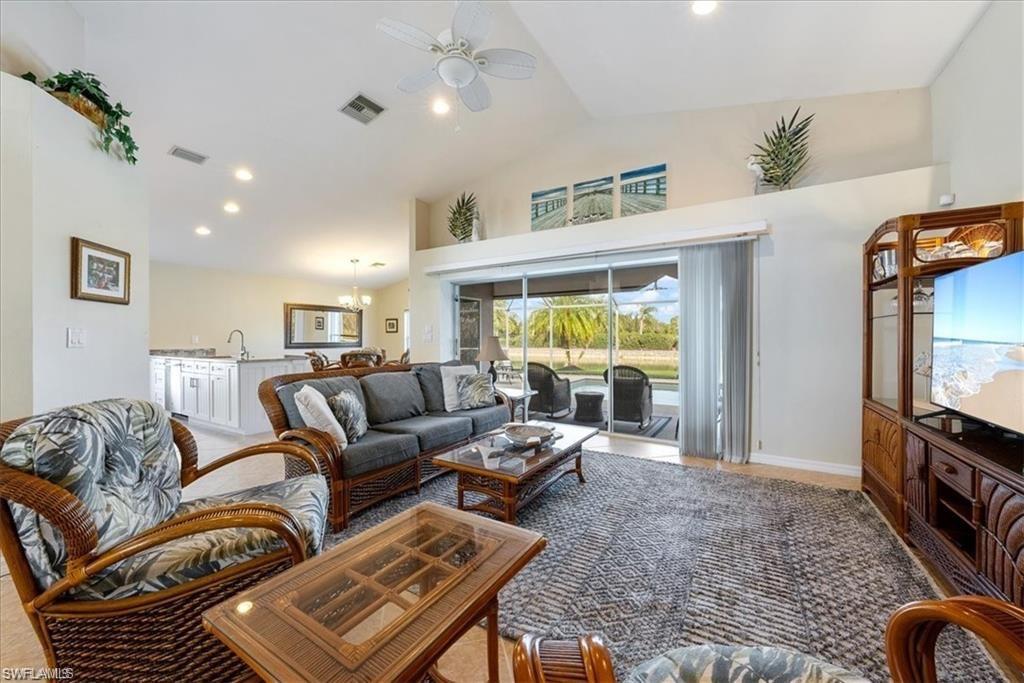 8432 Indian Wells Way Naples, FL 34113 - Photo 11 of 27 a living room with furniture ceiling fan and a rug