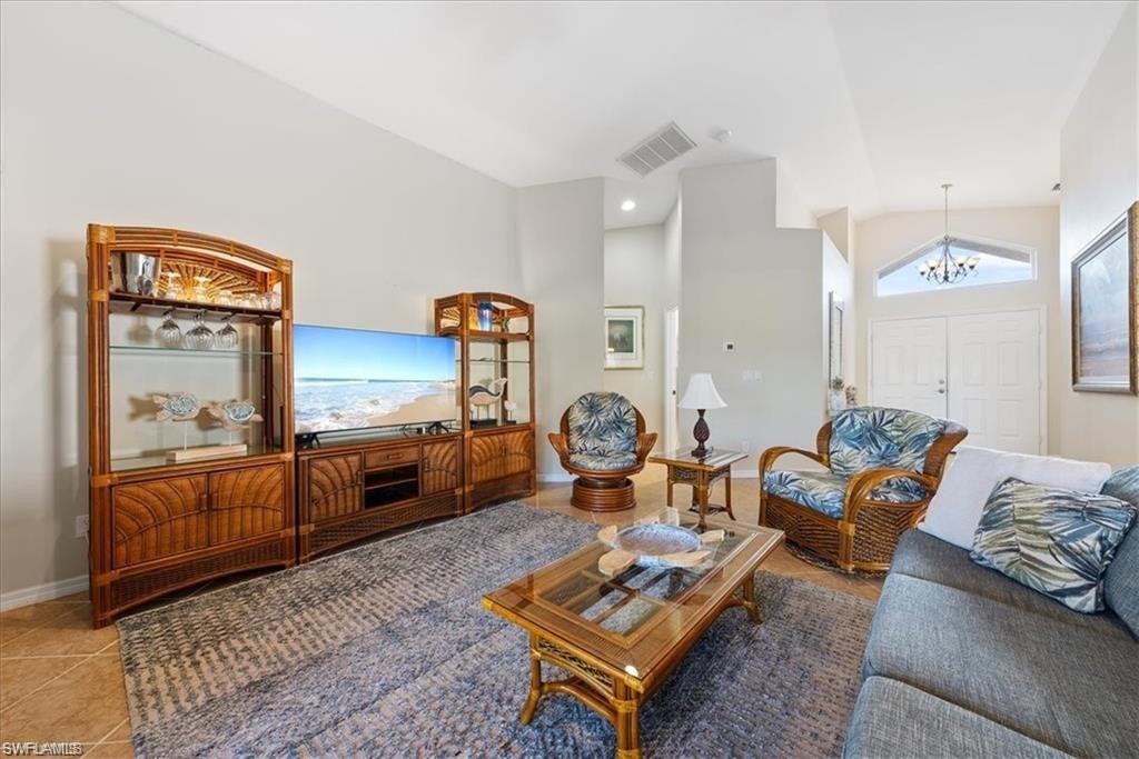 8432 Indian Wells Way Naples, FL 34113 - Photo 12 of 27 a living room with furniture and a couch