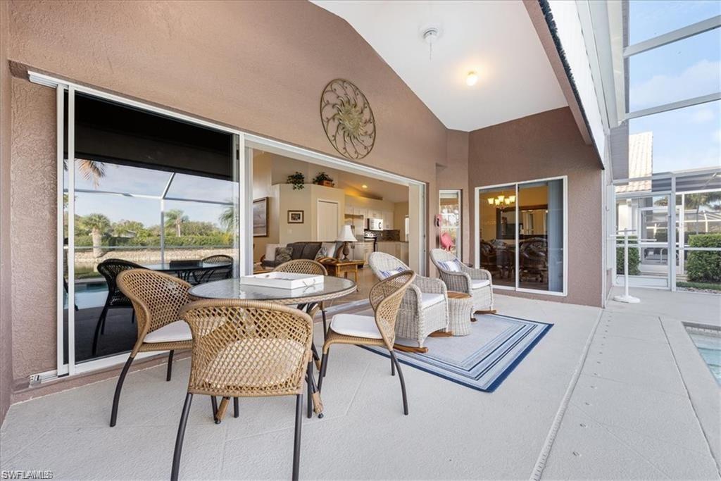 8432 Indian Wells Way Naples, FL 34113 - Photo 18 of 27 a living room with furniture and a large window