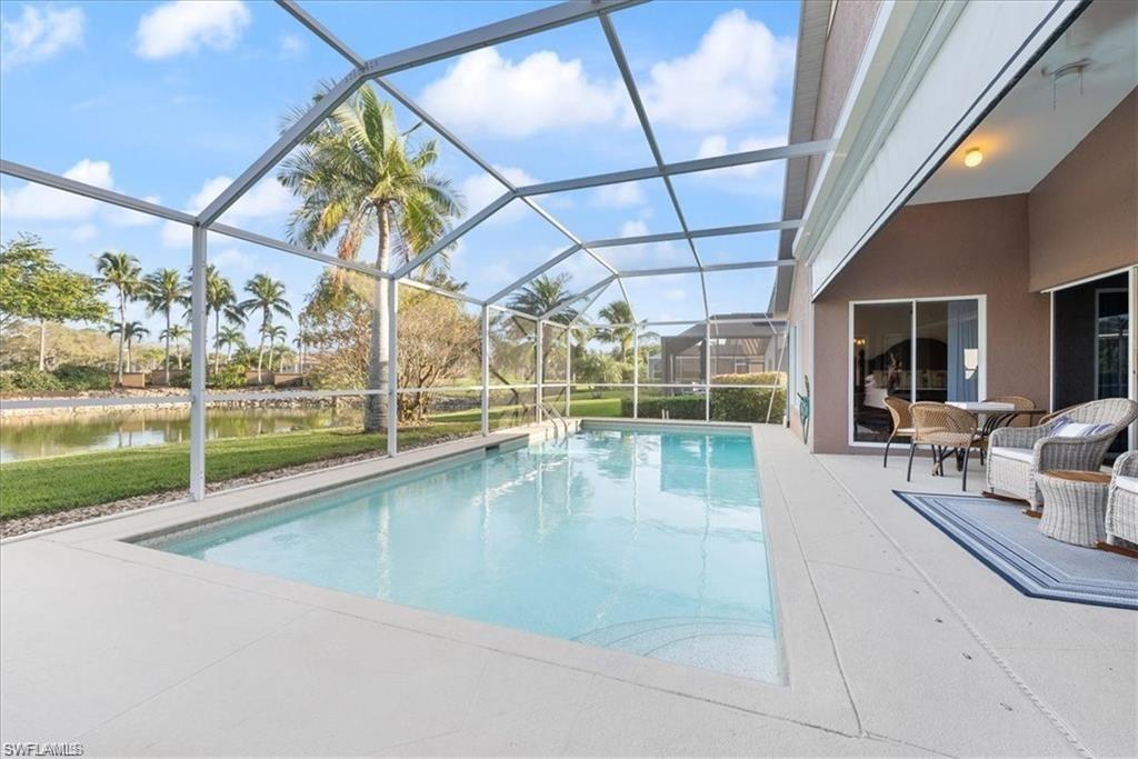 8432 Indian Wells Way Naples, FL 34113 - Photo 2 of 27 a view of swimming pool with outdoor seating