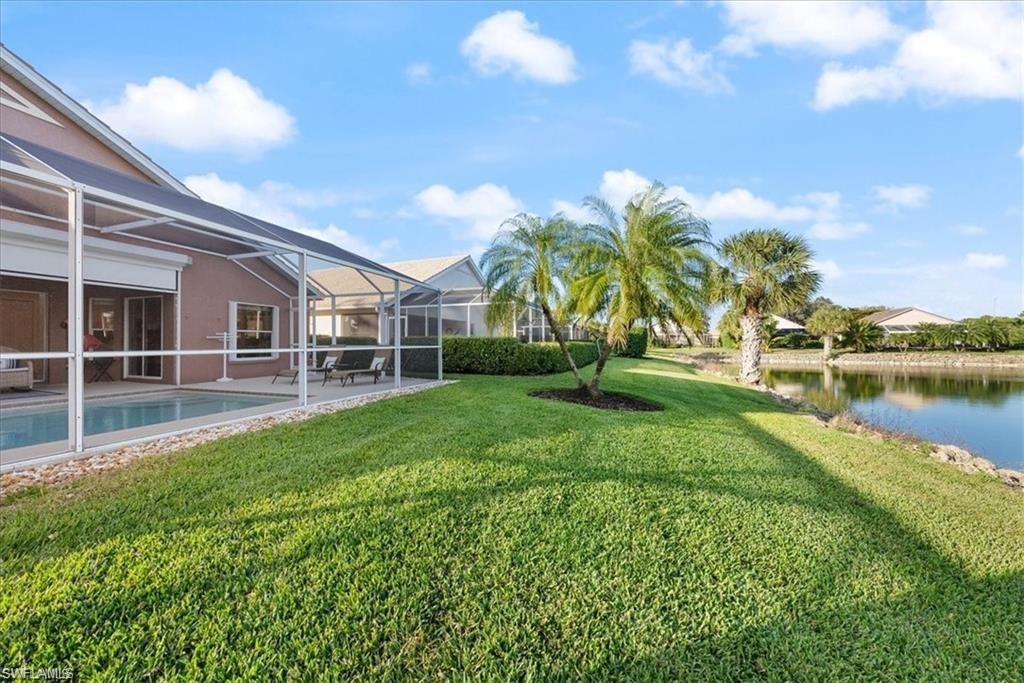 8432 Indian Wells Way Naples, FL 34113 - Photo 22 of 27 a view of a house with a big yard and a large tree