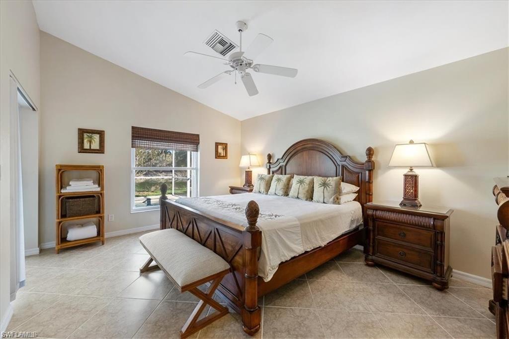 8432 Indian Wells Way Naples, FL 34113 - Photo 5 of 27 a bedroom with a bed and a dresser