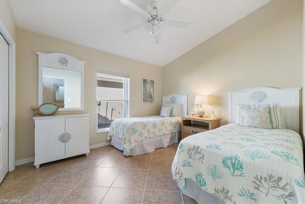 8432 Indian Wells Way Naples, FL 34113 - Photo 10 of 27 a bedroom with two beds and painted walls