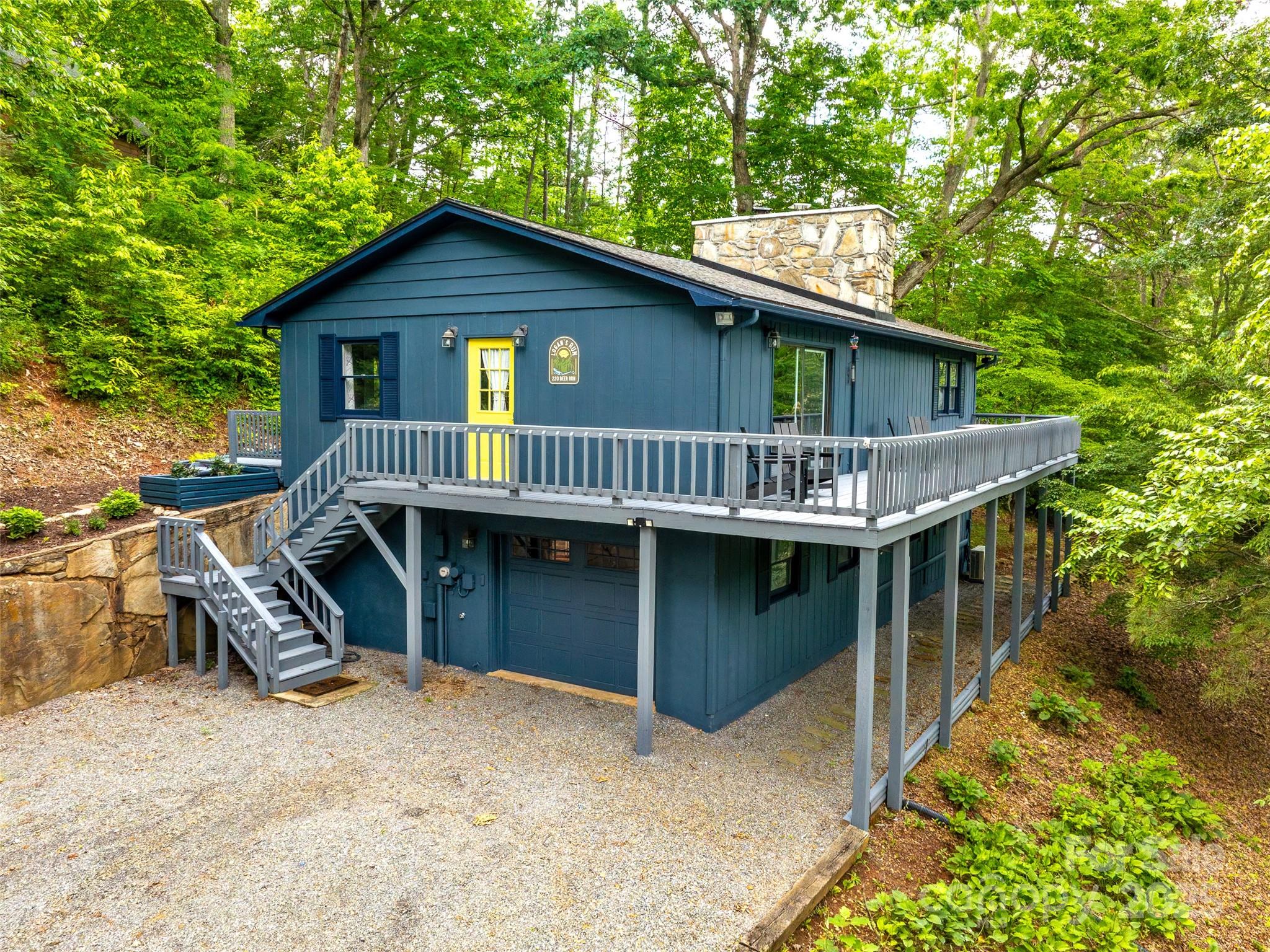 a view of a house with a yard deck and a patio