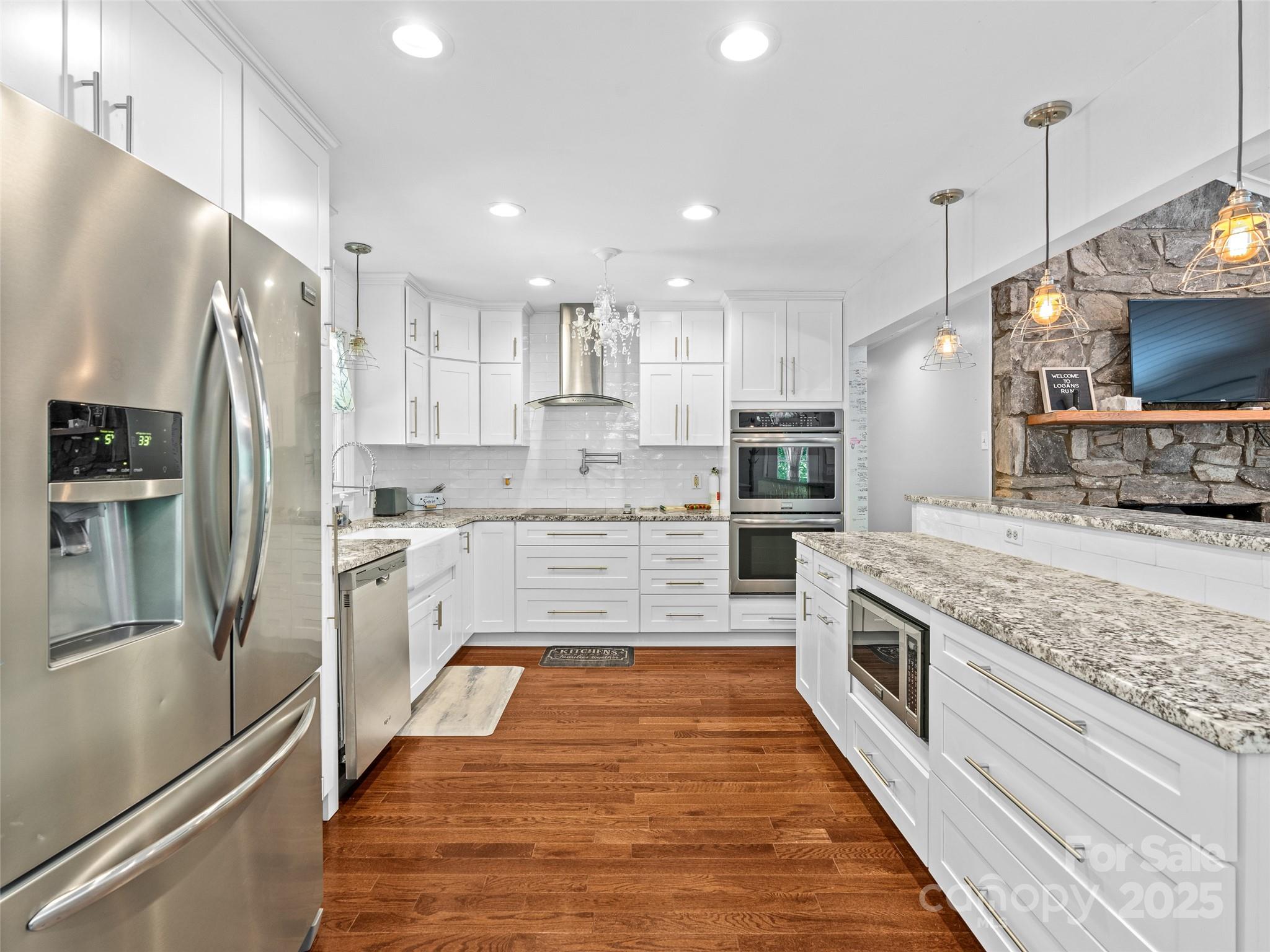 220 Deer Run Road Canton, NC 28716 - Photo 11 of 46 a large kitchen with stainless steel appliances kitchen island granite countertop a refrigerator and a stove top oven