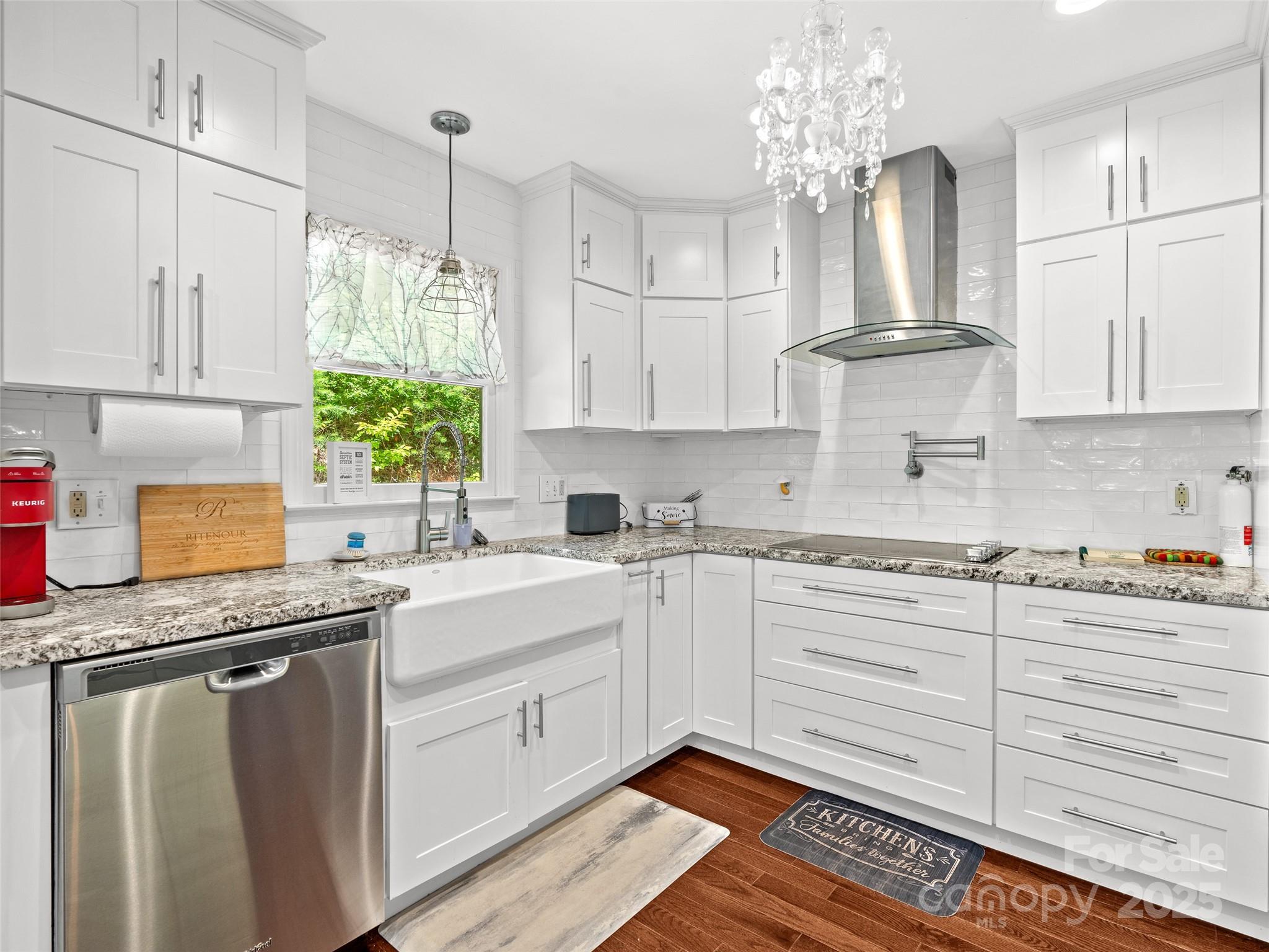 220 Deer Run Road Canton, NC 28716 - Photo 15 of 46 a white kitchen with granite countertop a stove a sink dishwasher and white cabinets with wooden floor