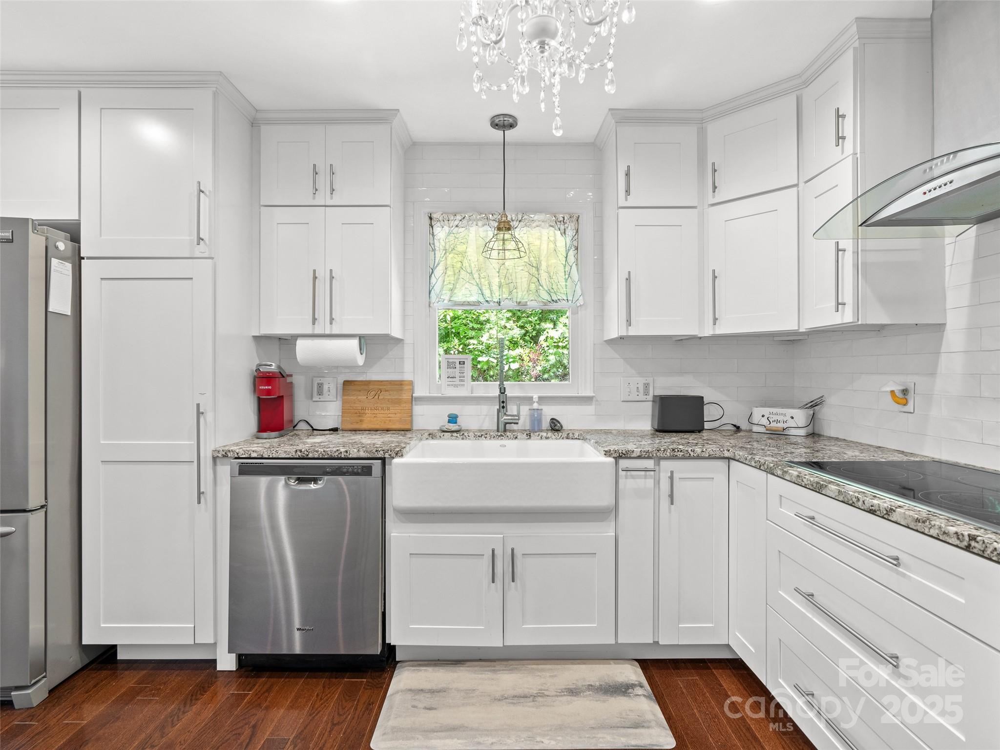 220 Deer Run Road Canton, NC 28716 - Photo 16 of 46 a kitchen with kitchen island granite countertop white cabinets white appliances a sink and a window