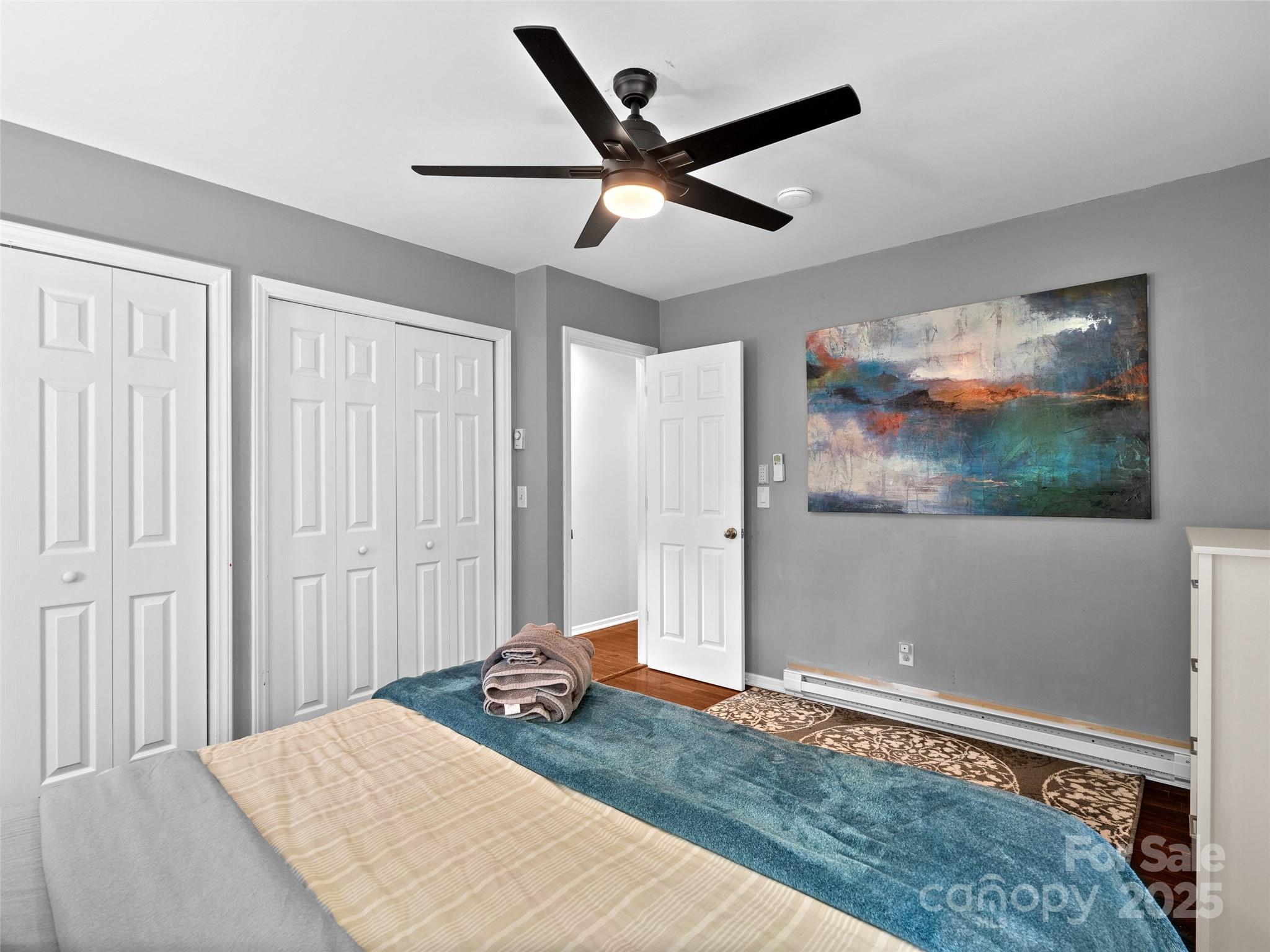 220 Deer Run Road Canton, NC 28716 - Photo 22 of 46 a bedroom with a bed and a painting on the wall