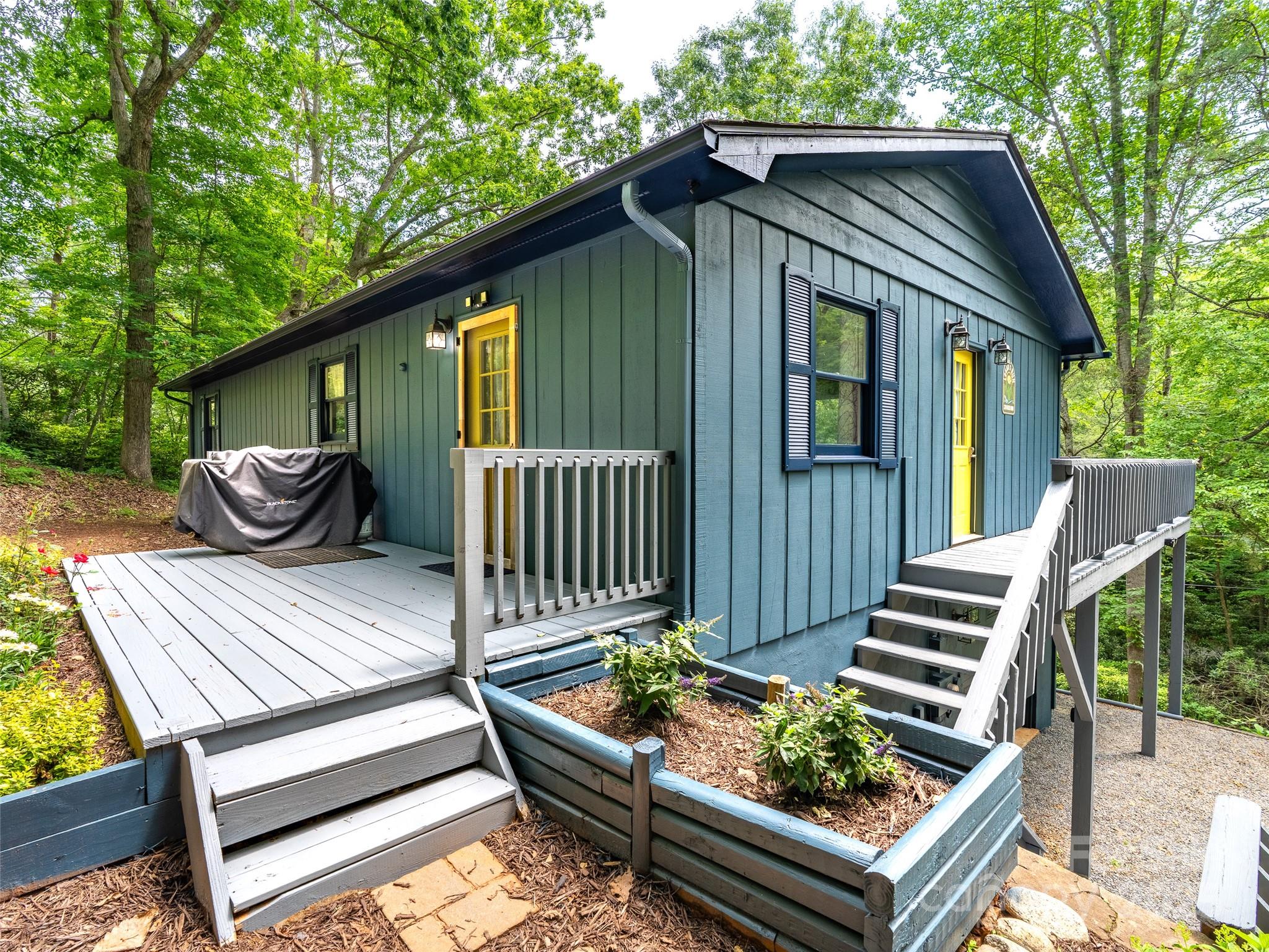 220 Deer Run Road Canton, NC 28716 - Photo 3 of 46 a front view of a house with wooden deck and furniture
