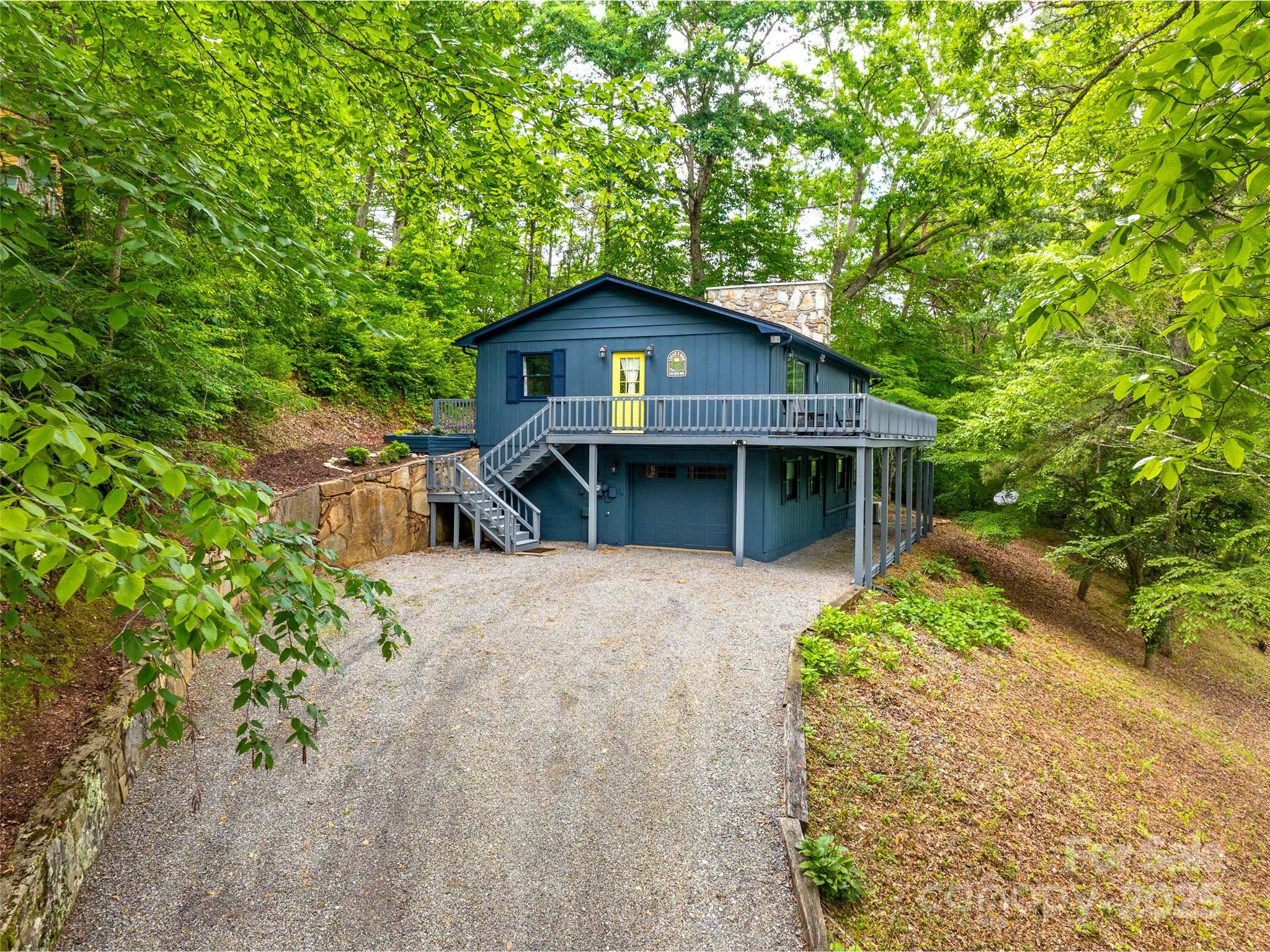 220 Deer Run Road Canton, NC 28716 - Photo 36 of 46 a front view of a house with a garden