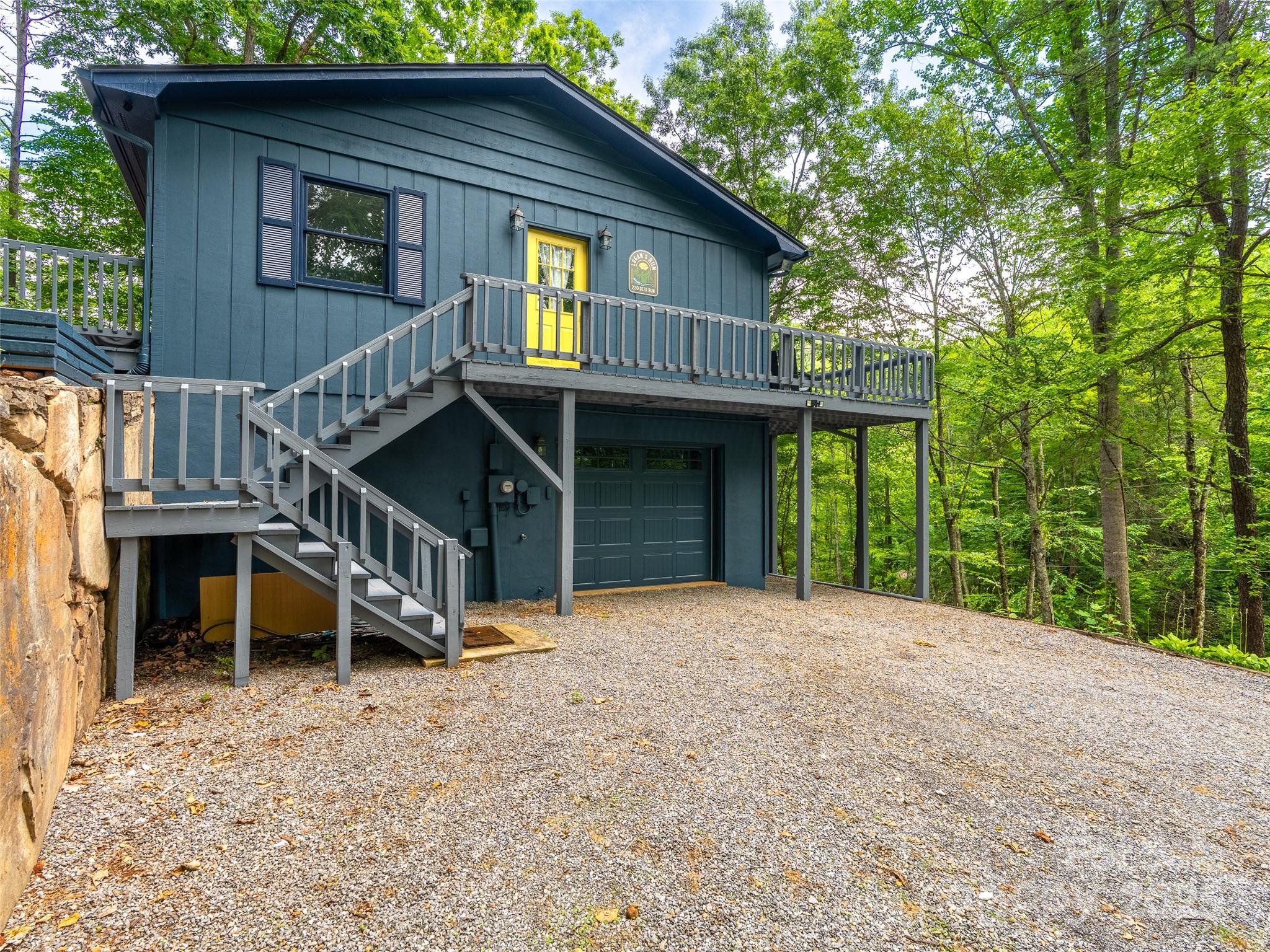 220 Deer Run Road Canton, NC 28716 - Photo 37 of 46 a view of a house with wooden deck and a backyard