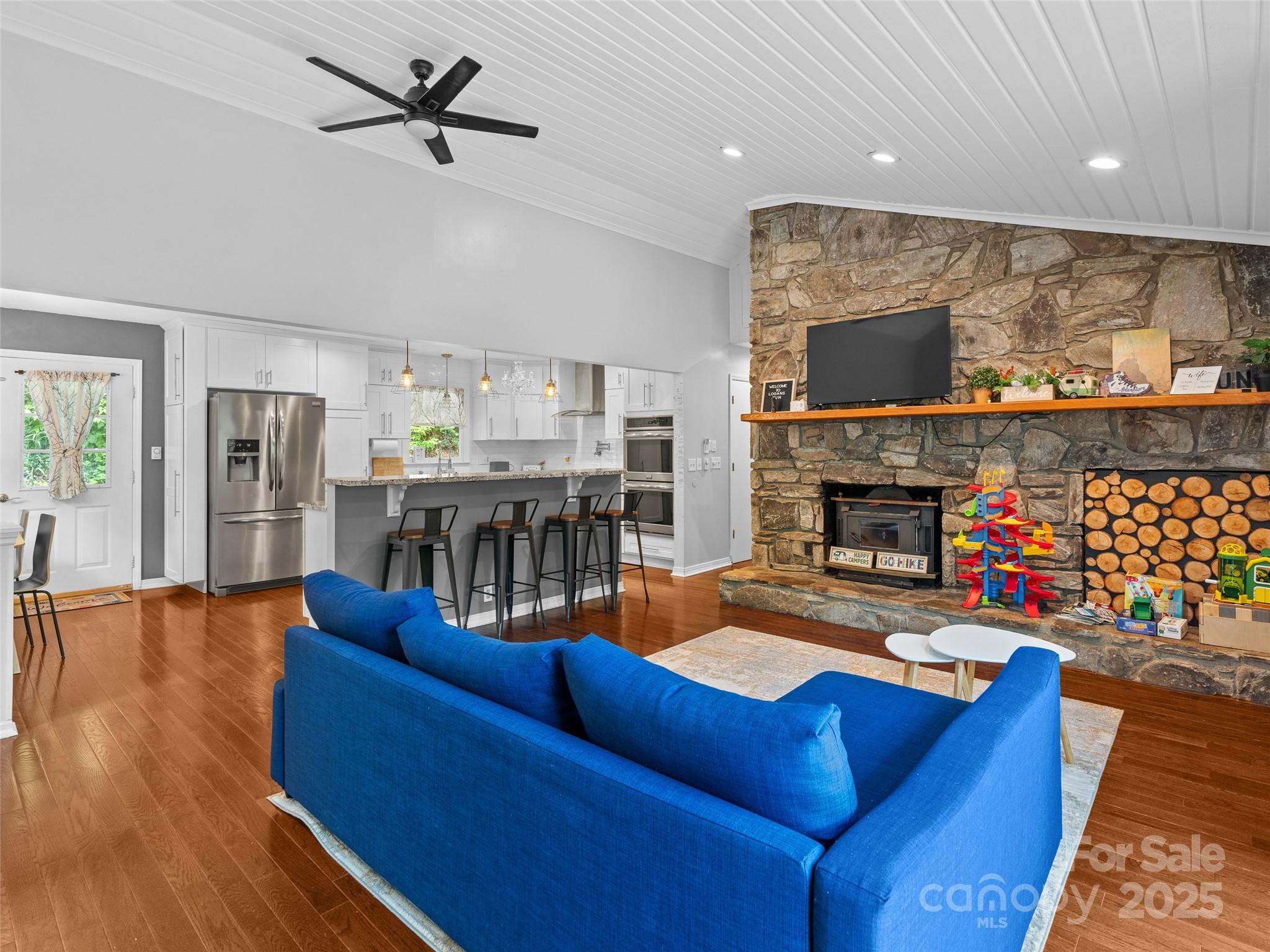 220 Deer Run Road Canton, NC 28716 - Photo 8 of 46 a living room with furniture a fireplace and a flat screen tv