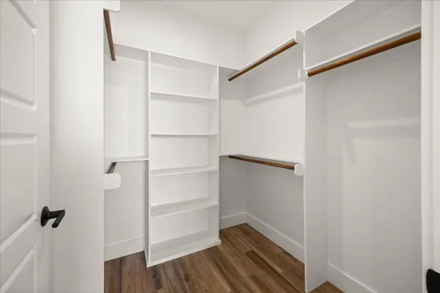 a view of walk in closet with empty racks