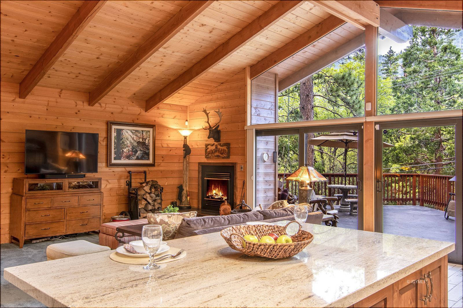24924 Fern Valley Road Idyllwild, CA 92549 - Photo 18 of 44 a dining room with furniture a fireplace and wooden floor