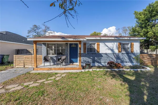 a view of a house with backyard porch and sitting area