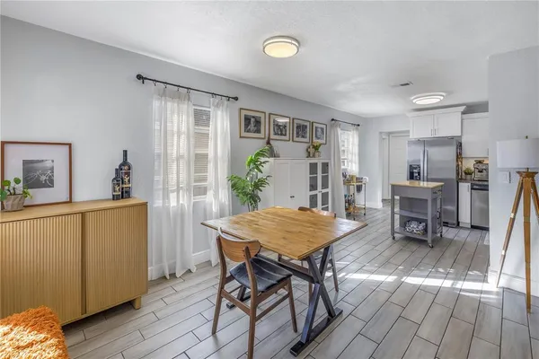 a dining room with furniture and window