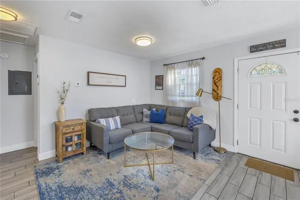 a living room with furniture a rug and a window