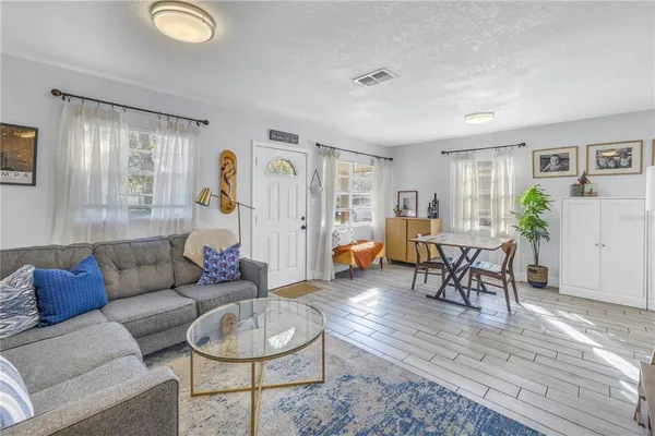 a living room with furniture and wooden floor