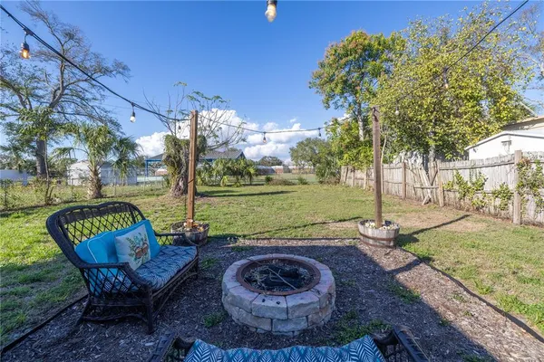 a view of a porch with furniture and a yard