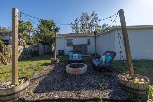a view of a porch with furniture and a fire pit