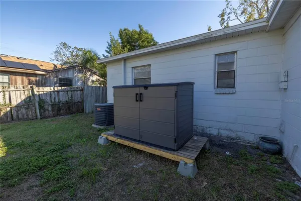 a wooden bench sitting in middle of a yard