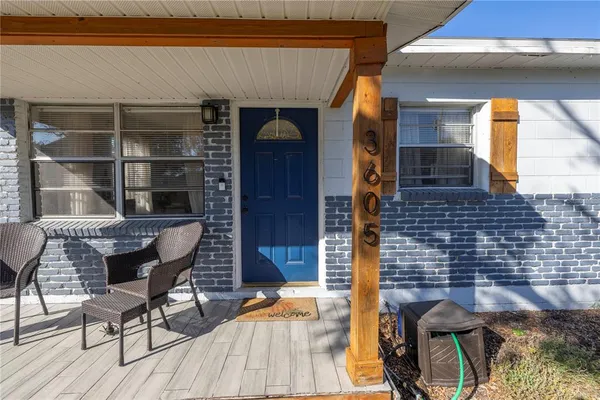 a balcony with table and chairs
