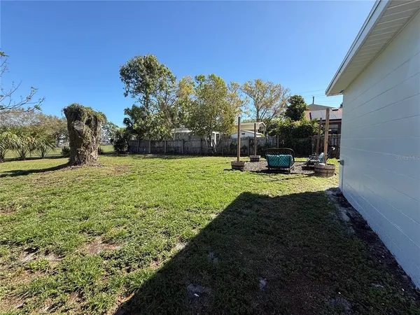 a view of yard with swimming pool and green space