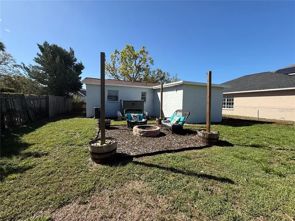 a view of a backyard with plants and a patio