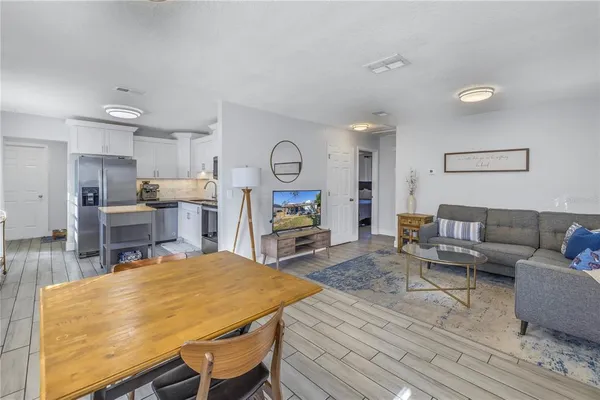 a living room with furniture and wooden floor