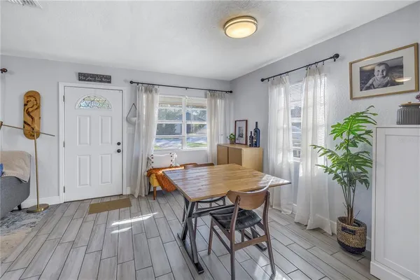 a view of a dining room with furniture and a potted plant