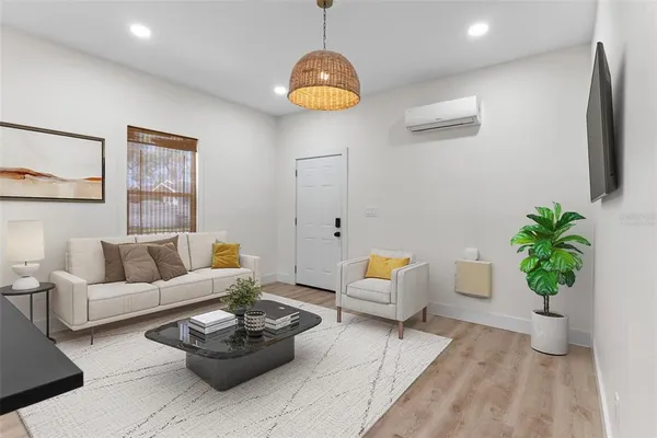 a living room with furniture and a potted plant