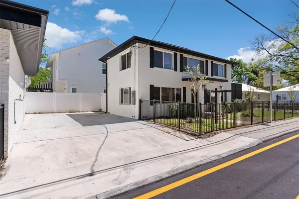 a view of a house with backyard and sitting area