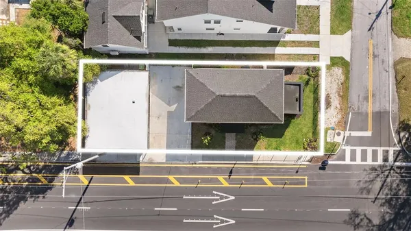 an aerial view of a house with a yard