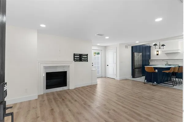 a view of kitchen with sink and fireplace